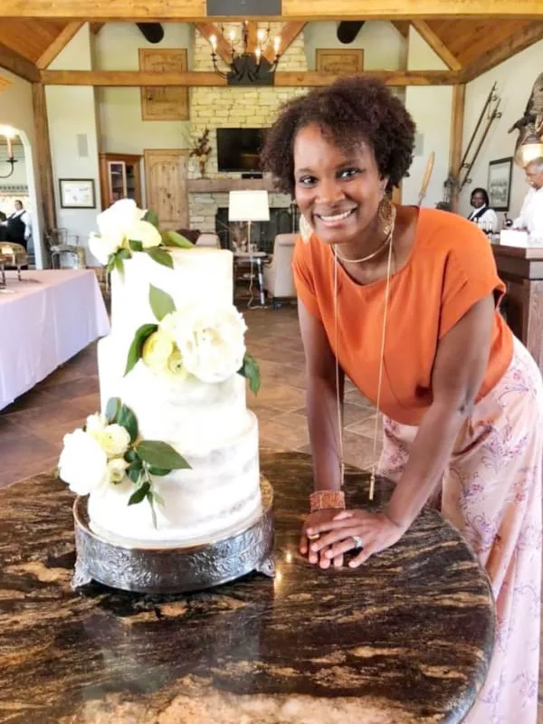 Delsia with a wedding cake she made